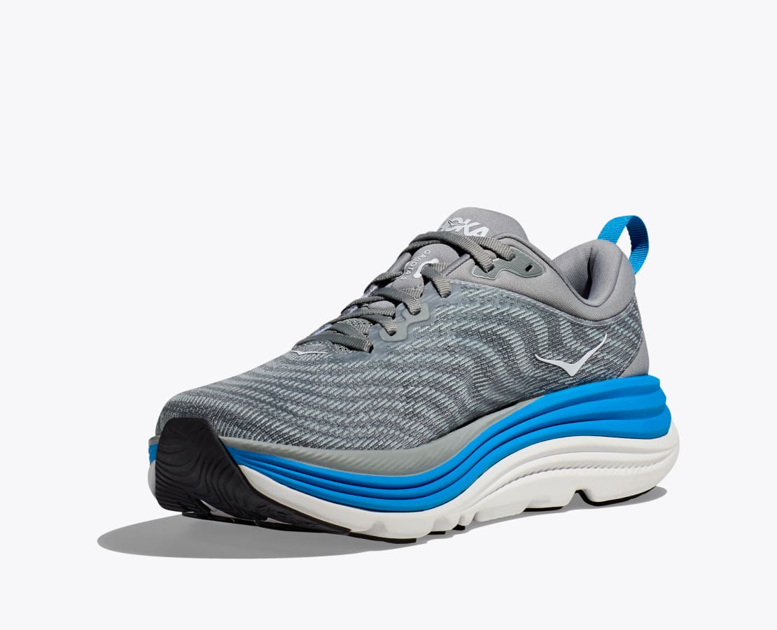 Hoka M Gaviota 5. Stabil och mycket dämpad springsko i herrmodell. Grå toner i färg med vita och blåa detaljer. Hos Hoka specialisterna i Sverige.