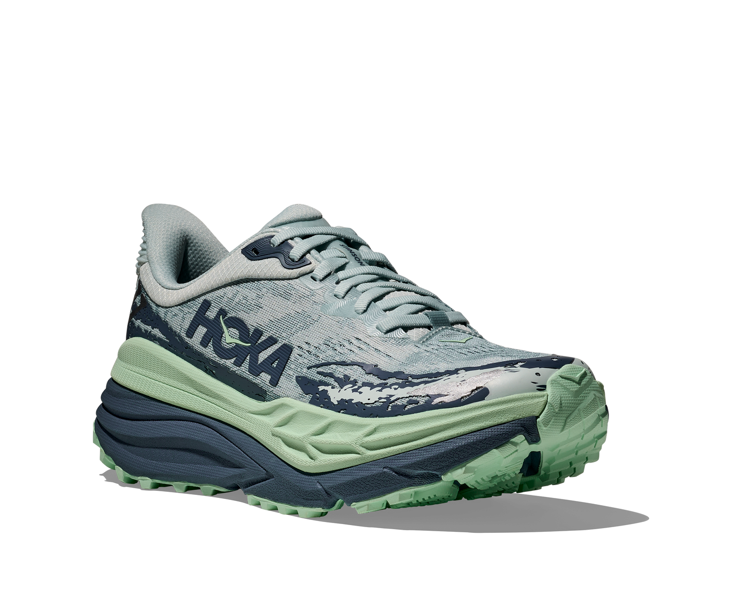 Hoka Stinson 7 W, dammodell hybridsko för alla underlag. En av Hokas stabilaste skor med pronationsstöd. En väldämpad sko som avlastar rygg och knä. Färg i nyanser av grönt och blått.