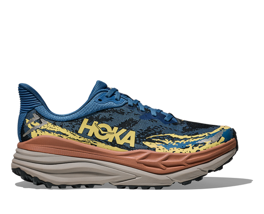 Hoka Stinson 7 M, herrmodell. Hybridsko för alla underlag. En av Hokas stabilaste skor med pronationsstöd. En väldämpad sko som avlastar rygg och knä. Färgen här är blå , gul, brun och grå. 