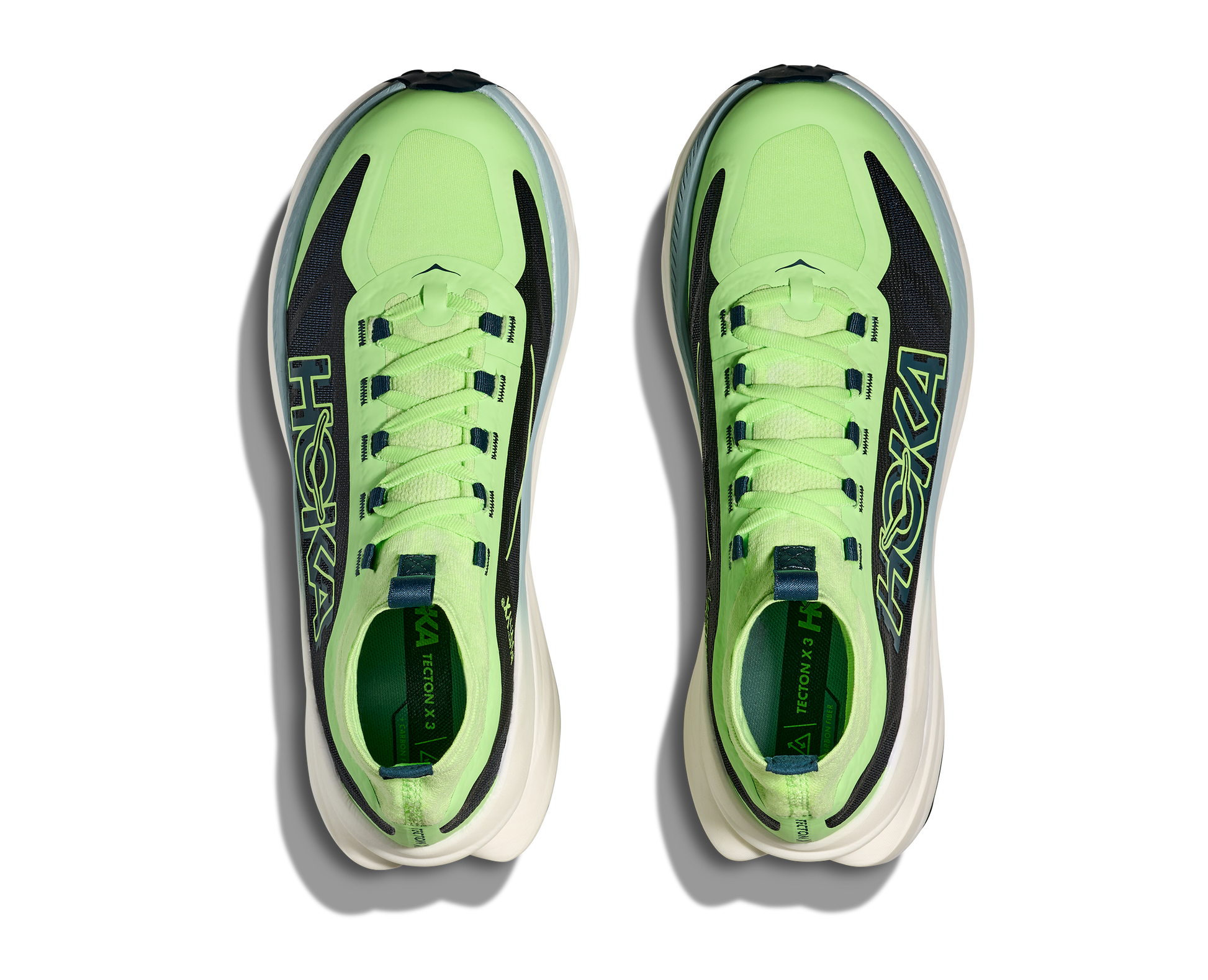 Hoka Tecton X 3 M, herrmodell. En av marknadens snabbaste trailsko med en delad kolfiberplatta. Strump-design för att skydda fötterna ifrån smuts och skräp. Färgen går i grönt och svart med vit sula och små detaljer i andra färger. 