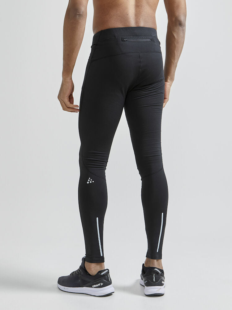 Craft ADV Essence Warm Tights. Svarta tights med elastisk resår i midjan samt dragsko för perfekt passform. Ficka med blixtlås baktill. Reflekterande detaljer samt logga på låret.