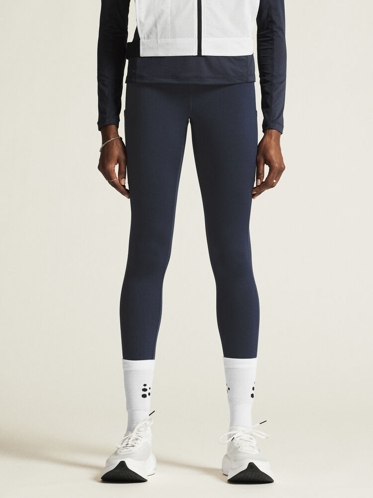 Craft ADV Essence High Waist Warm Tights. Mörkblå tights i dammodell med bred resår i midjan. Två stora ytterfickor på benen samt nyckelficka i midjan. 