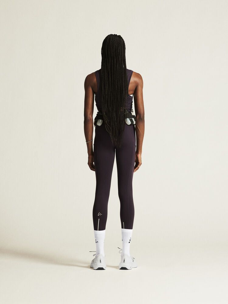 Craft ADV Essence High Waist Warm Tights. Lila tights i dammodell med bred resår i midjan. Två stora ytterfickor på benen samt nyckelficka i midjan. 