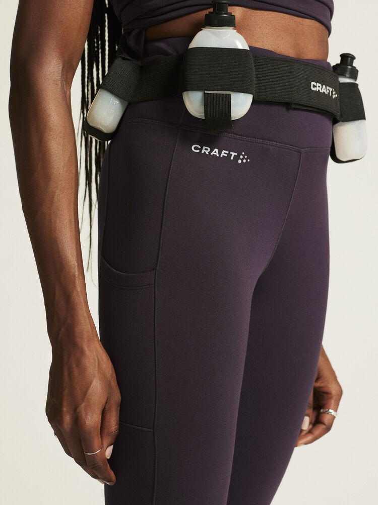 Craft ADV Essence High Waist Warm Tights. Lila tights i dammodell med bred resår i midjan. Två stora ytterfickor på benen samt nyckelficka i midjan. 